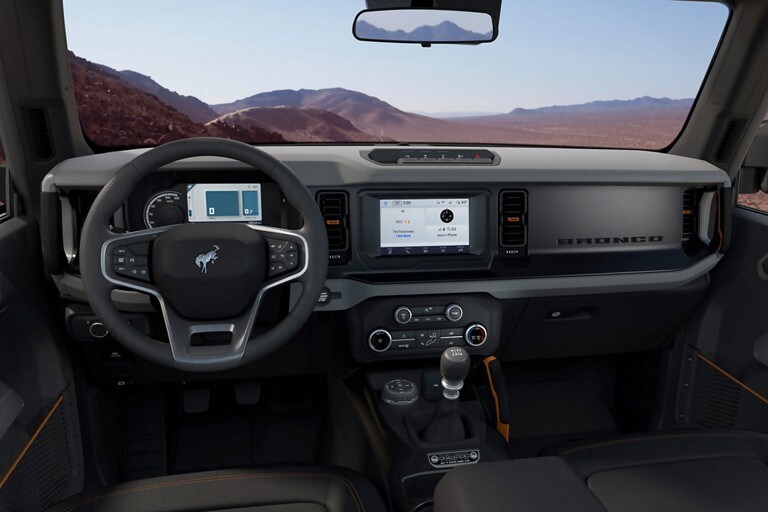 2023 Ford Bronco® interior with available leather-wrapped steering wheel with Bronco badge, cruise and audio controls