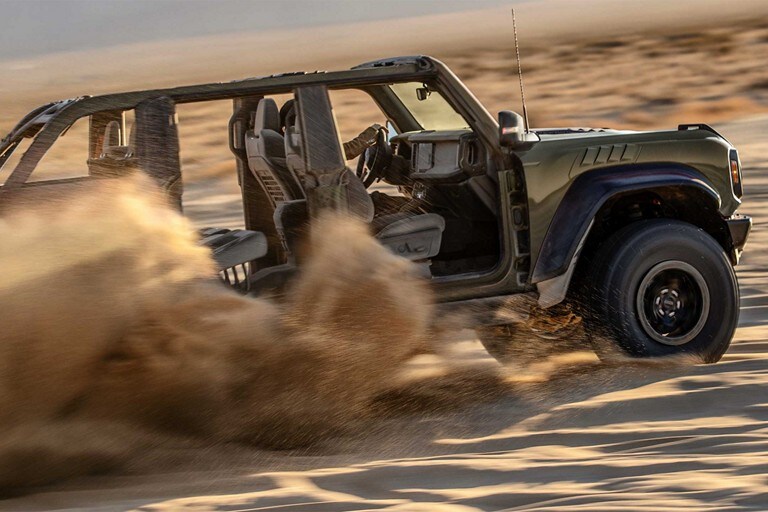2024 Ford Bronco® Raptor® in Shelter Green driving through desert