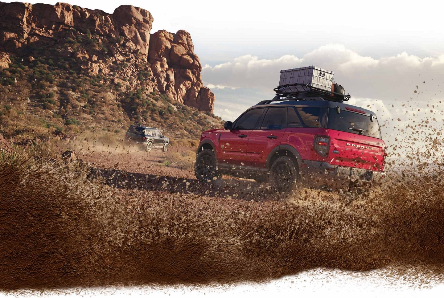 2025 Ford Bronco® Sport being driven near a rocky cliff with dirt kicked up around the vehicle