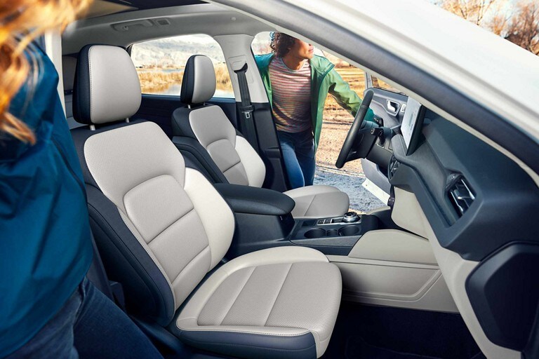 Interior shot of a 2023 Ford Escape® as two people start to enter it