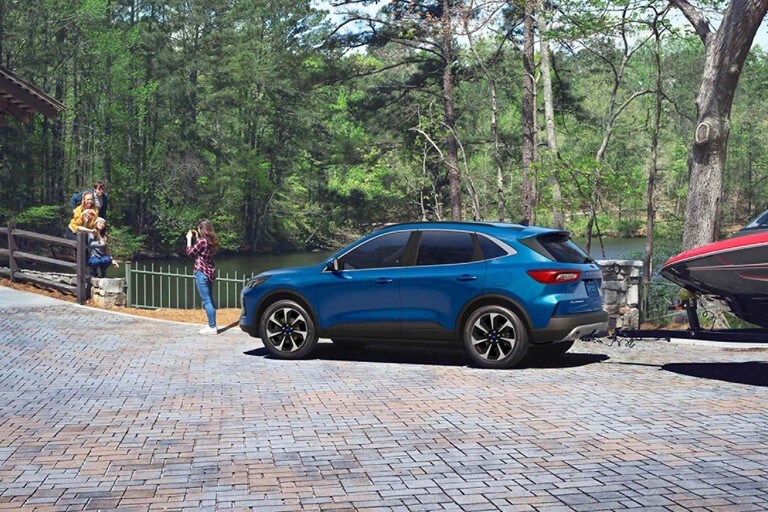 2023 Ford Escape® Platinum in Atlas Blue towing a boat