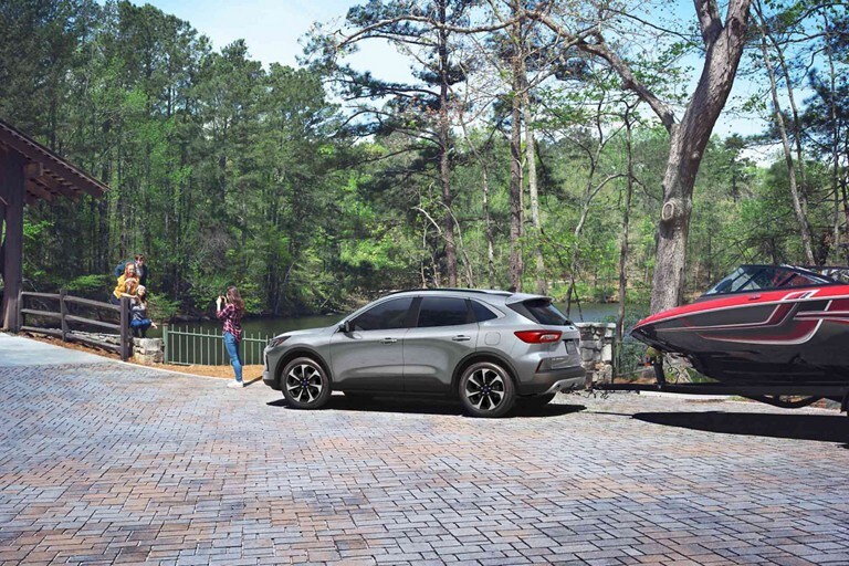 2024 Ford Escape® Platinum in Atlas Blue towing a boat