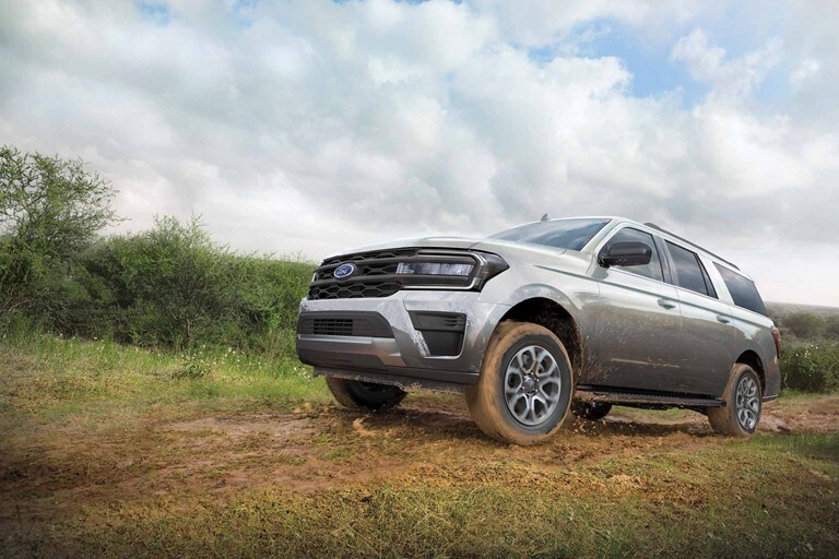 18" wheels shown on a 2023 Ford Expedition XLT being driven on a muddy road