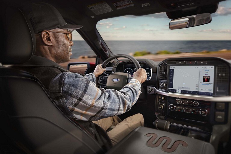 A man behind the wheel of a 2023 Ford F-150®