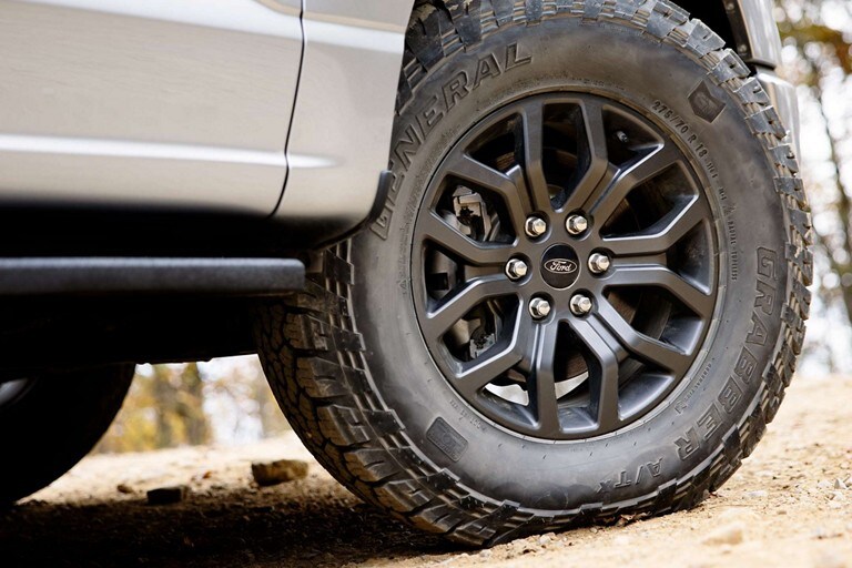 Close-up of 18-inch aluminum wheels in Dark Matte finish on a 2023 Ford F-150® Tremor®
