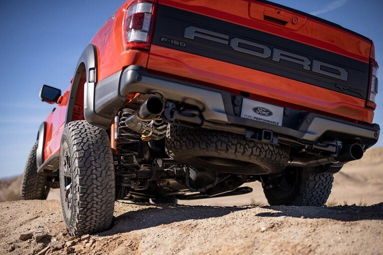Close-up of rear suspension as 2023 Ford F-150® Raptor® truck is driven over rough terrain
