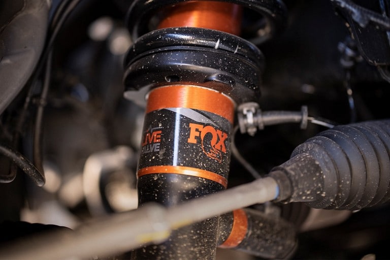 Close-up of FOX™ Live Valve™ shocks installed on the Raptor®