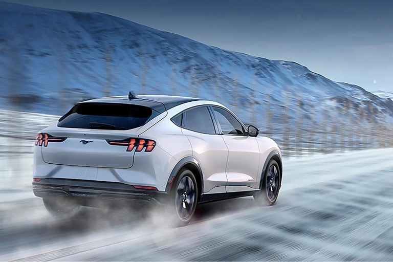 2023 Ford Mustang Mach-E® SUV being driven on a road with winter conditions