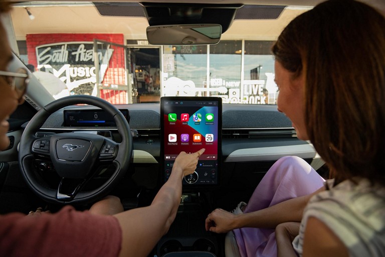 A person using SYNC® 4A on the 15.5-inch touchscreen of the 2024 Ford Mustang Mach-E® SUV
