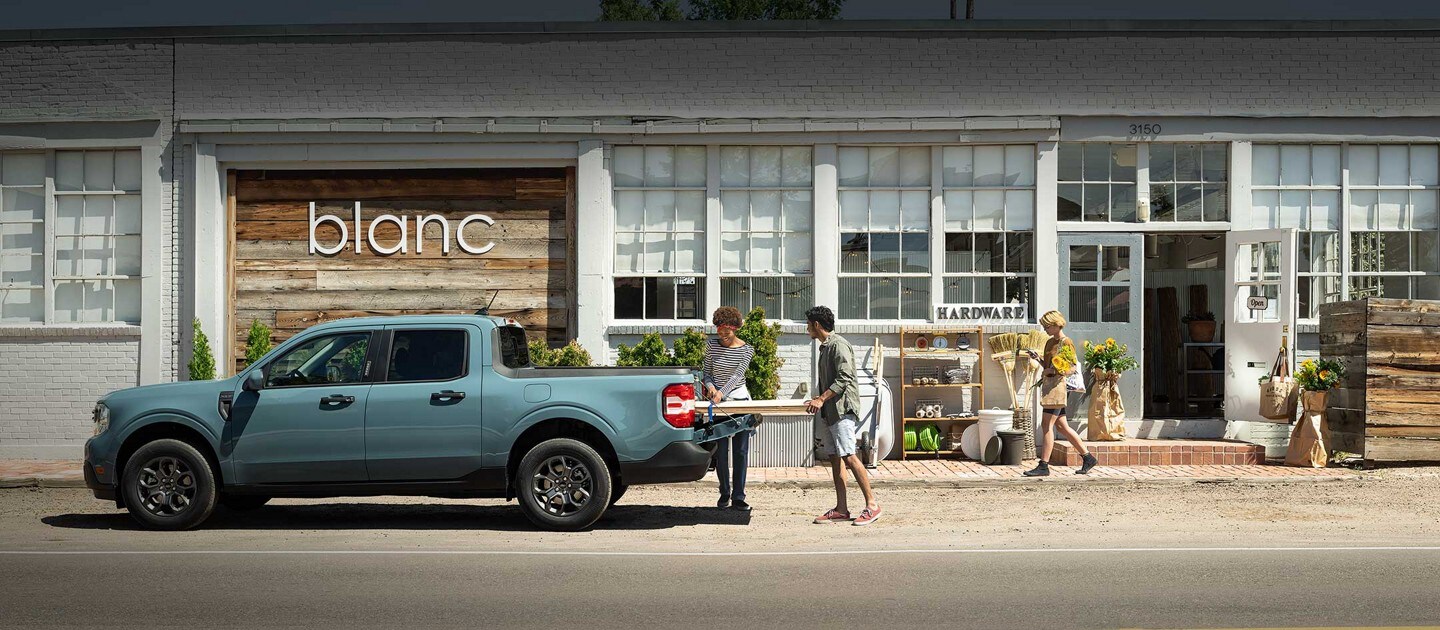 2023 Ford Maverick® in Area 51 parked outside a store called Blanc as people load lumber