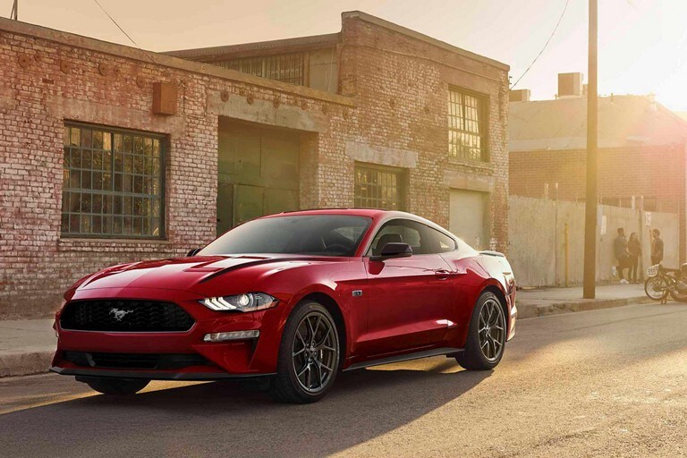 2023 Ford Mustang® coupe in Race Red parked on a street