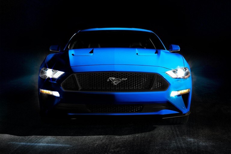 A 2023 Ford Mustang® coupe parked in a dark garage