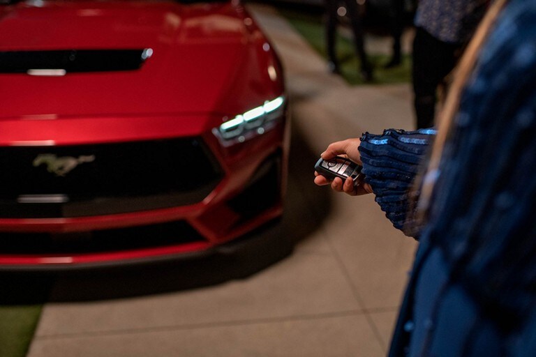 Person using the remote rev feature on a 2024 Ford Mustang® model