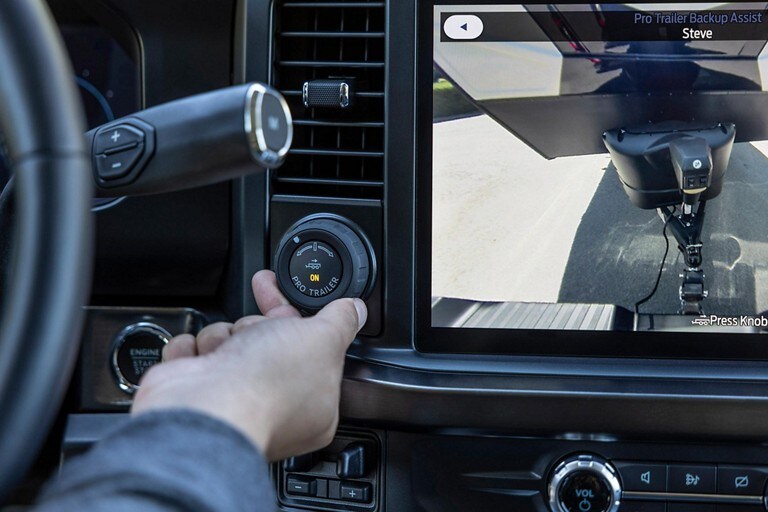 Close-up of a person using the Pro Trailer Backup Assist™ knob