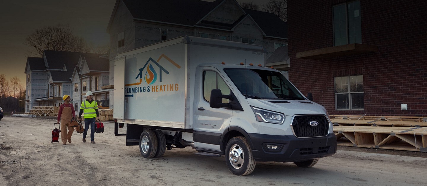 A 2023 Ford Transit® Chassis Cab with two people at a construction site