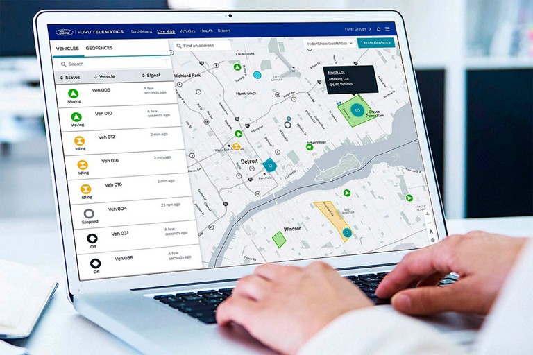 Person using available Ford Pro™ Telematics on a laptop