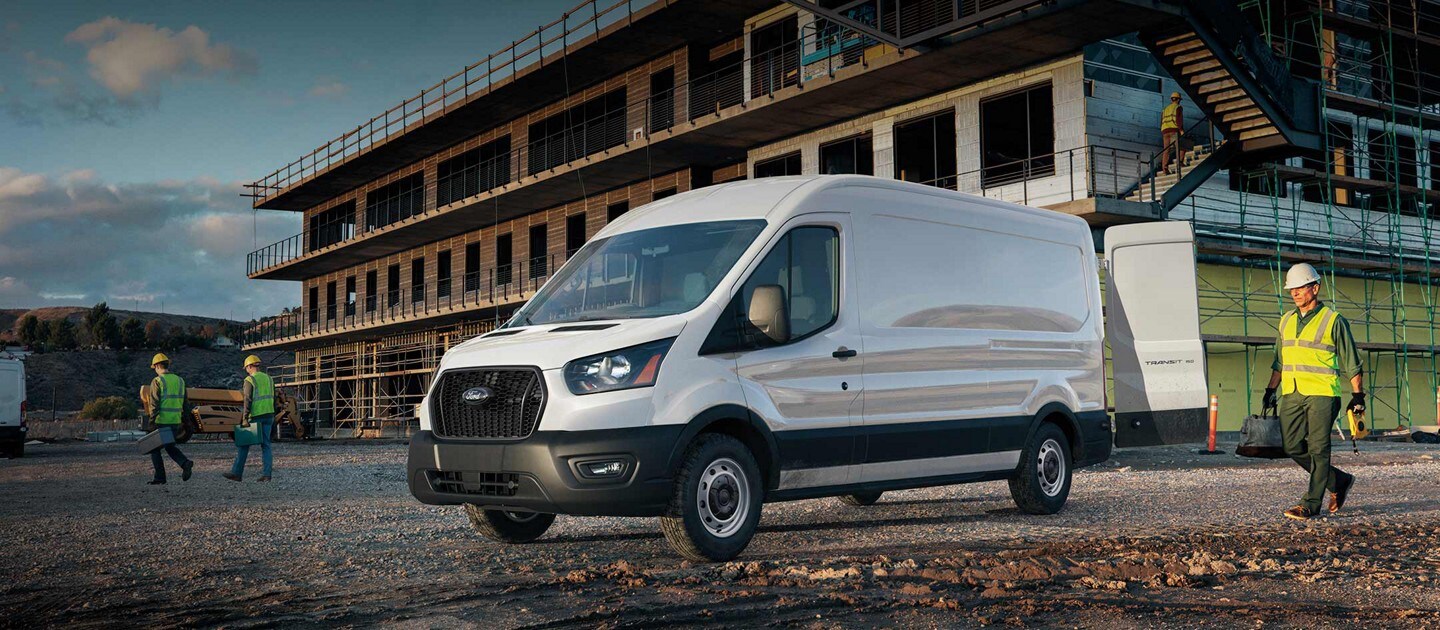 2024 Ford Transit® van parked in front of construction site with workers nearby