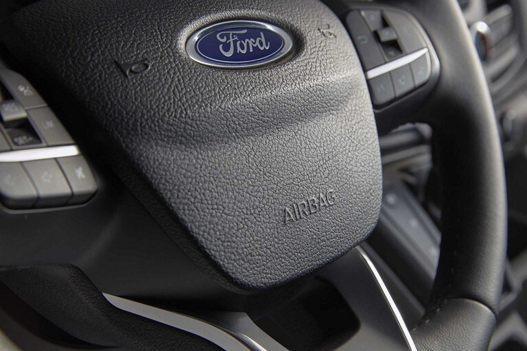 Tight shot of steering wheel inside a 2023 Ford Transit® van