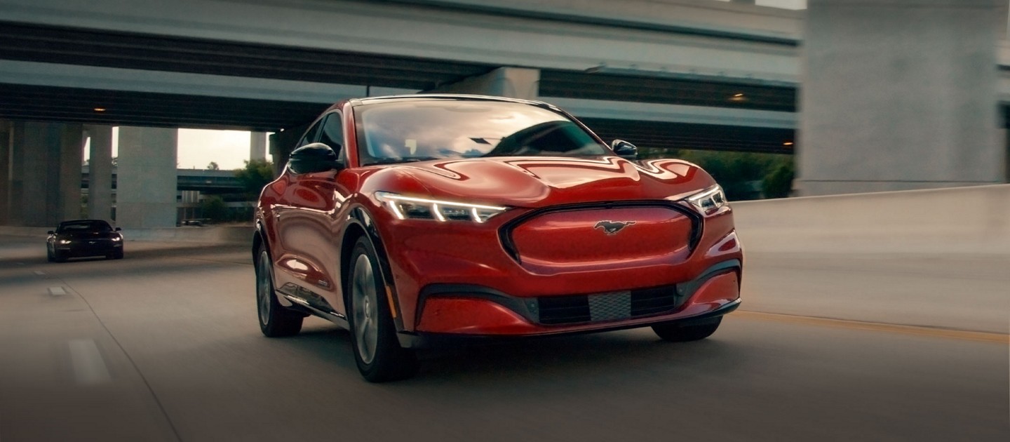 Mustang Mach-E driving on an urban road.