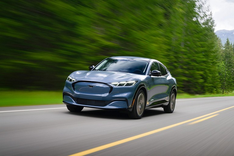 Mustang Mach-E driving on a two-lane highway.