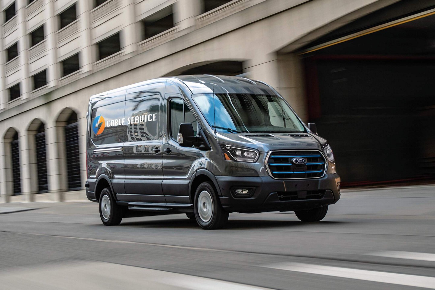 E-Transit driving on an urban road.