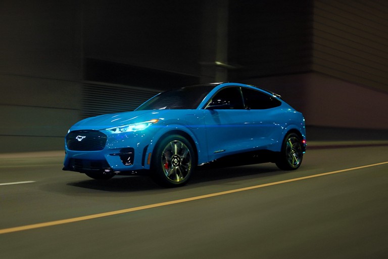 Mustang Mach-E driving on an urban road. 