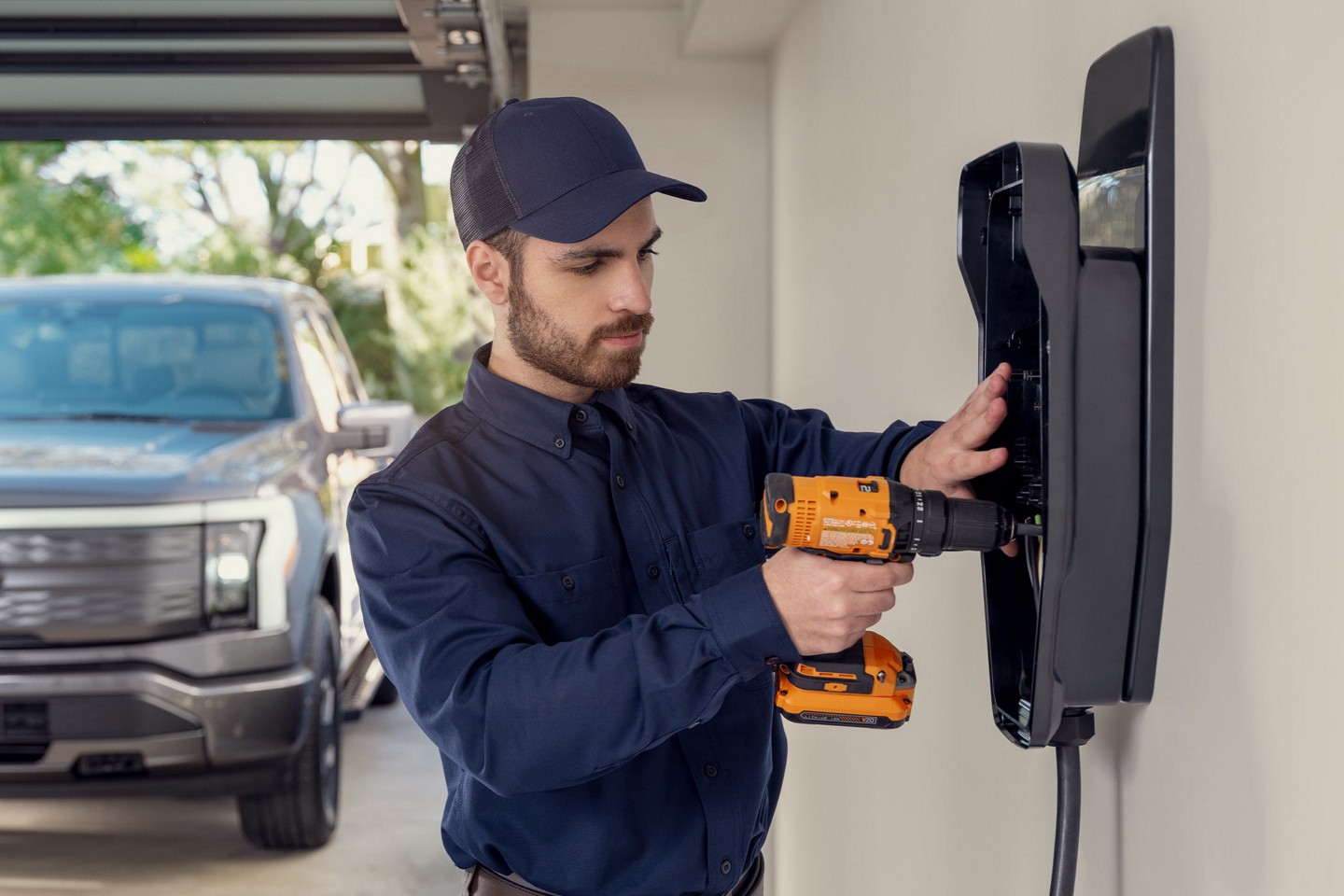 Service person installing a Ford home charging station.