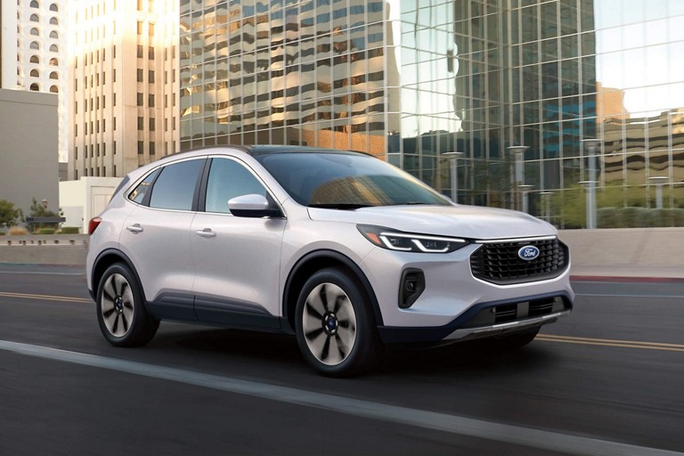 Ford Escape driving on an urban road.