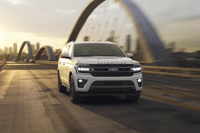 Ford Expedition driving across a bridge.