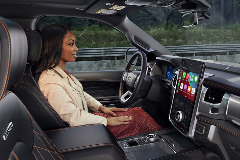 Woman drives a Ford vehicle hands-free.
