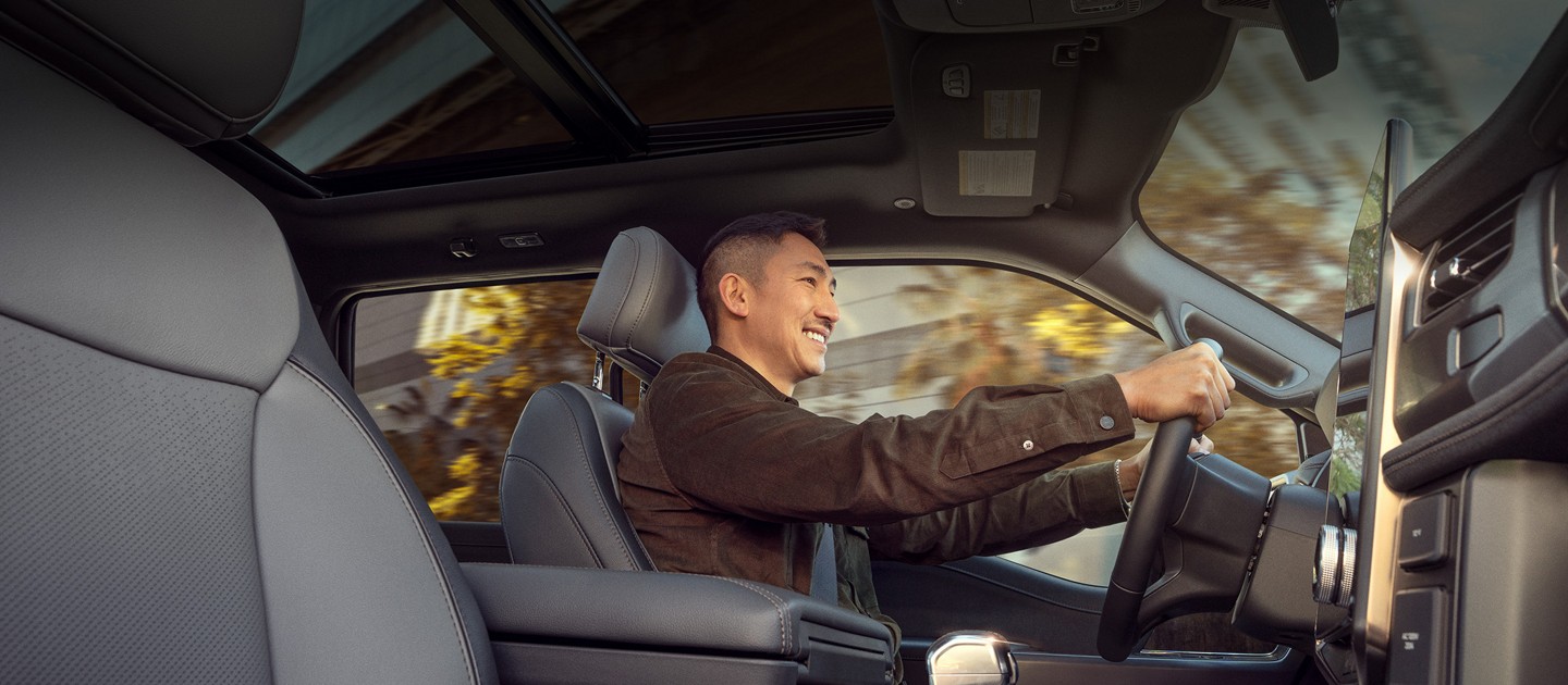 Interior view of a man driving an F-150 Lightning. 