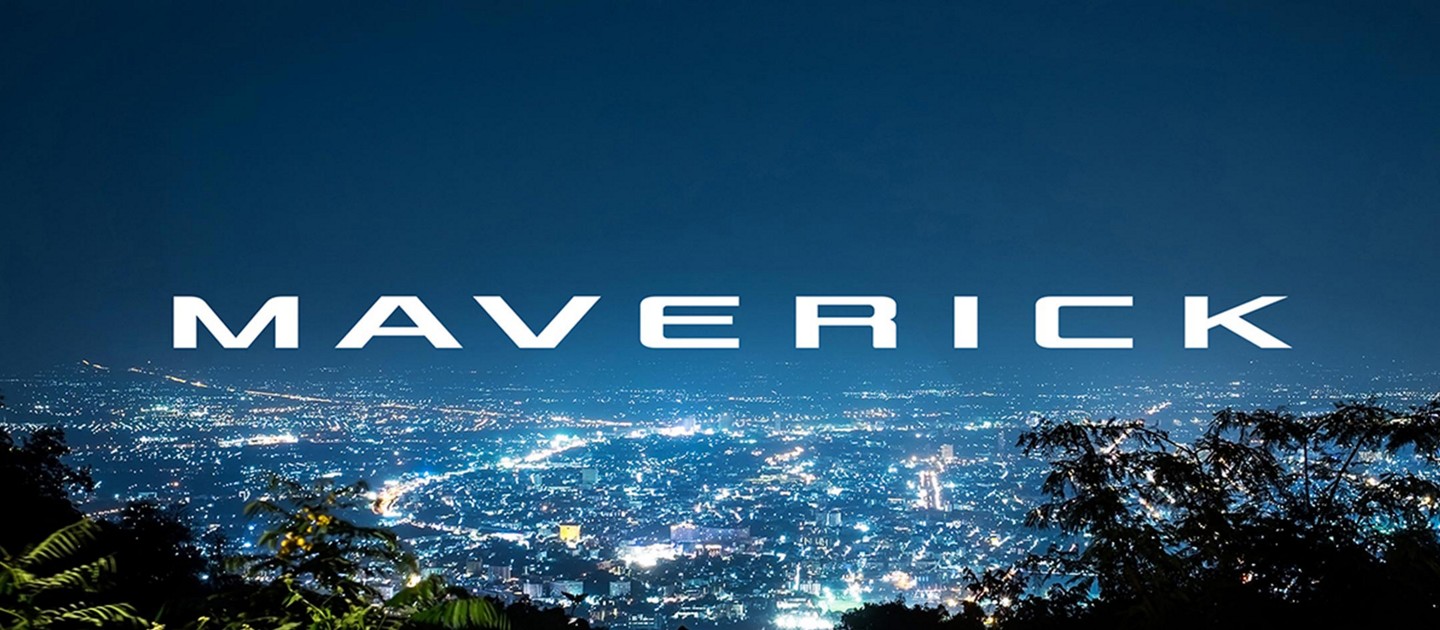 Cityscape at night with the word Maverick in sky