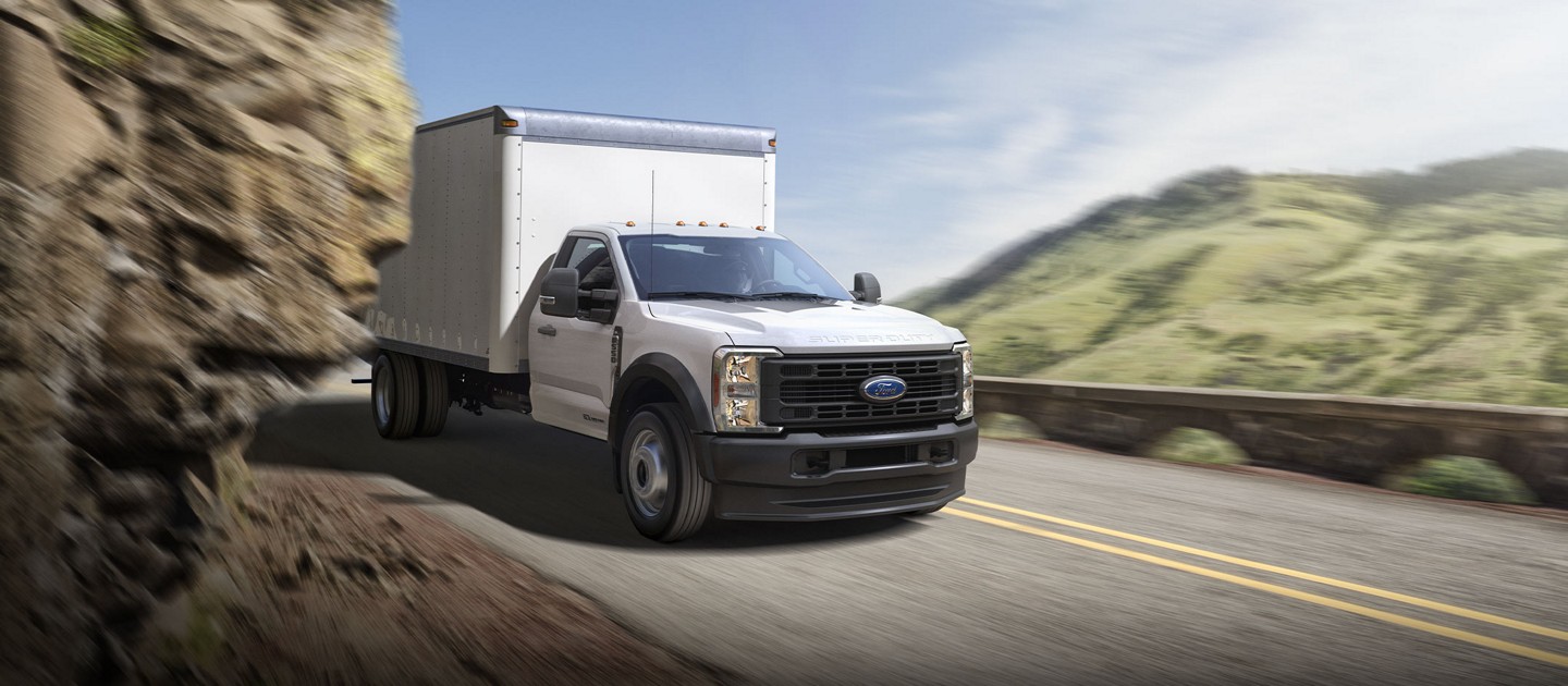 2025 Ford Super Duty® F-450® XL with a box being driven through a tight mountain curve