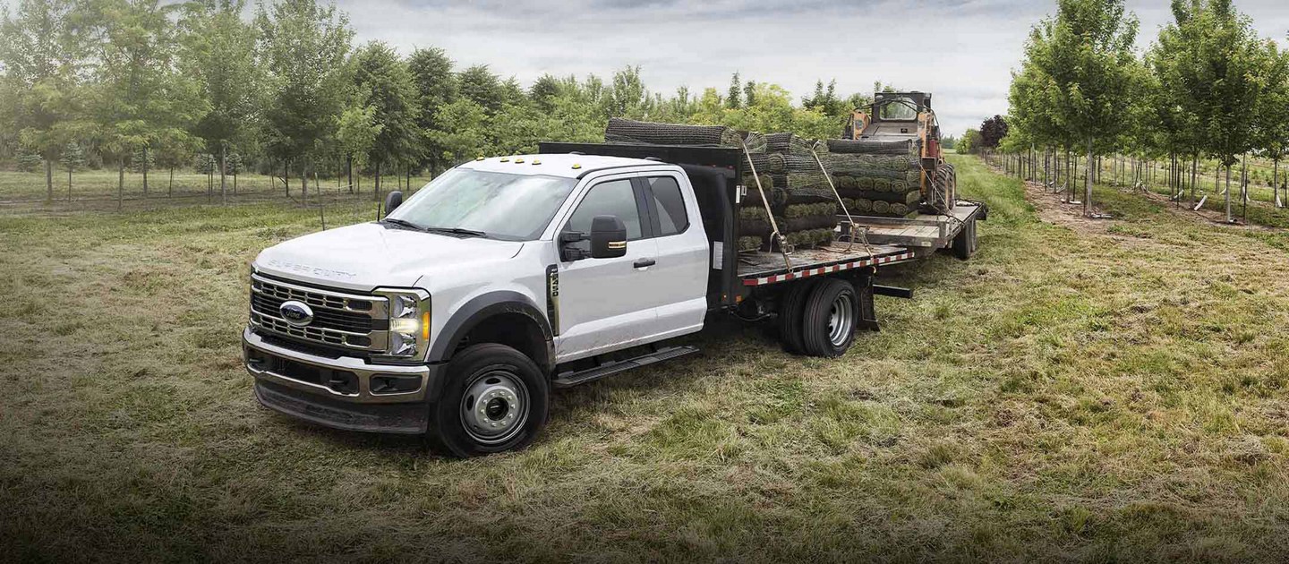2025 Ford Super Duty® F-350® loaded with sod and pulling a trailer with a Bobcat