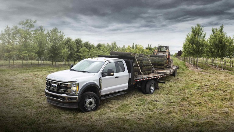 2025 Ford Super Duty® F-350® loaded with sod and pulling a trailer with a Bobcat