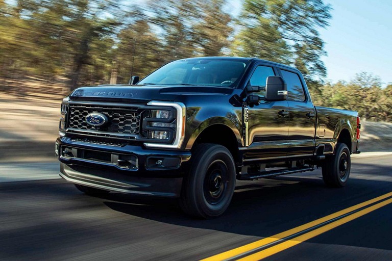 2025 Ford Super Duty® STX® Package pickup in Agate Black Metallic being driven on a paved road