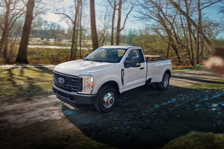 2025 Ford Super Duty® F-350® XL DRW in Oxford White being driven on a dirt road