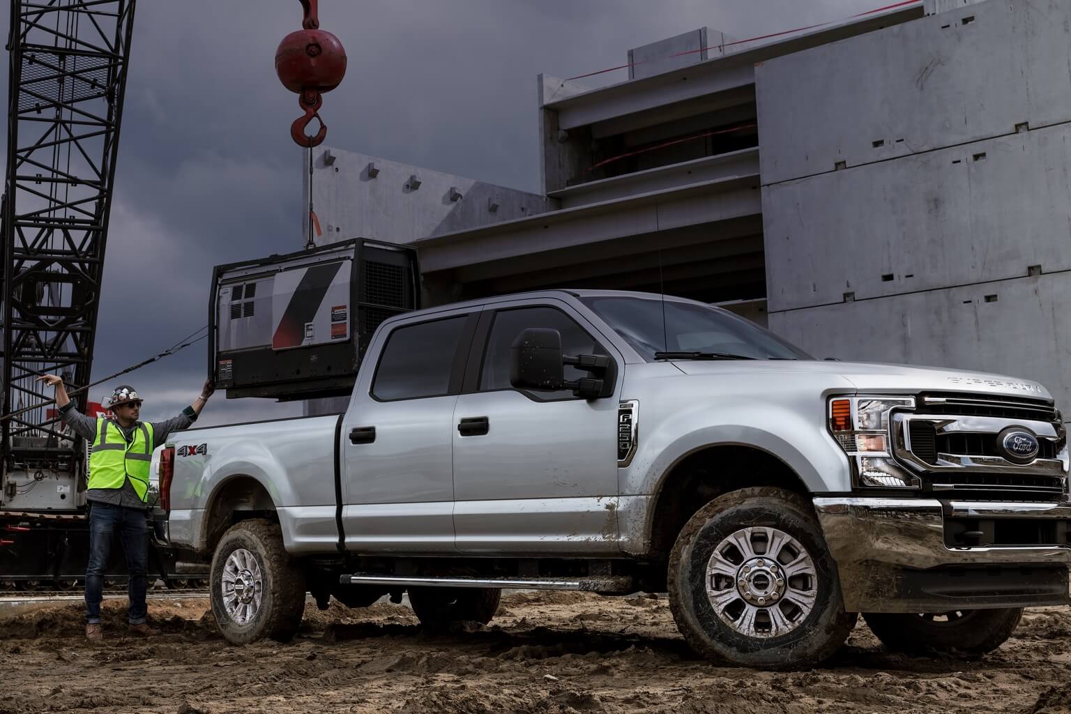 Ford truck on Logging site with worker next to truck.