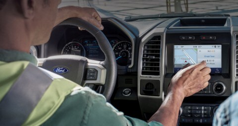 Man on cellphone getting ready to enter vehicle