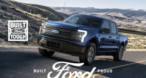 An all-electric Ford F-150 Lightning pickup truck on a mountain road