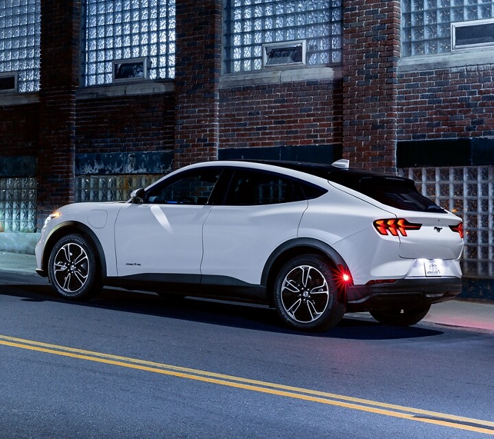 A 2021 Ford® Mustang Mach-E stopped on a city street