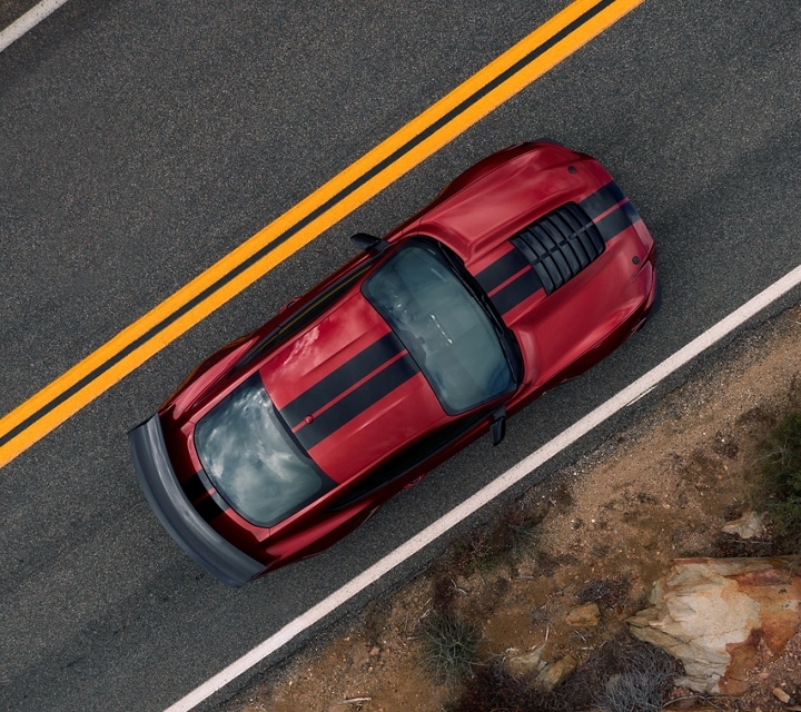 An overhead view of a 2021 Ford® Mustang GT500™ on a two-lane highway