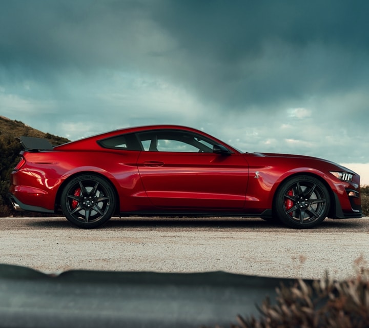A 2021 Ford® Mustang GT500™ in rapid red with a mountain in the background