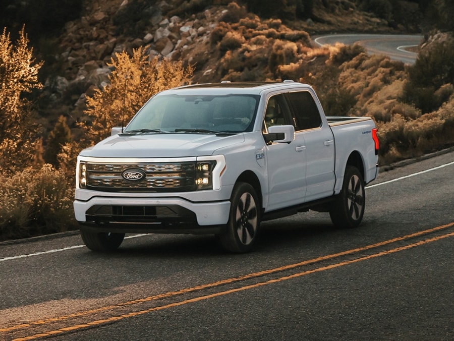 F-150 Lightning driving on a two-lane mountain road.  