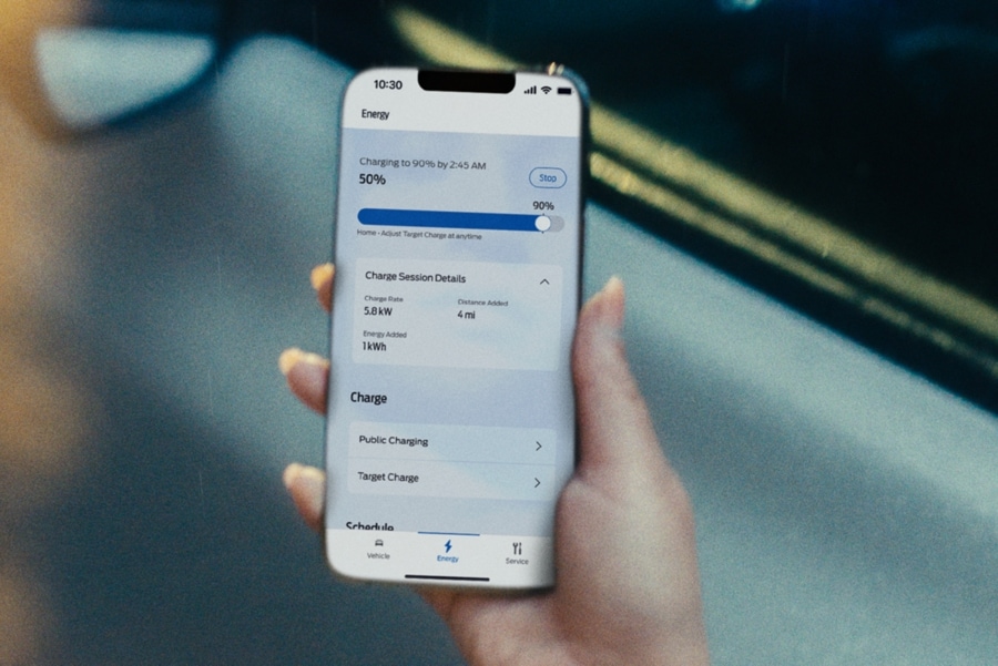 A person holding a cell phone with the FordPass app.