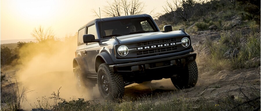 The 2023 Ford Bronco driving on rugged terrain.