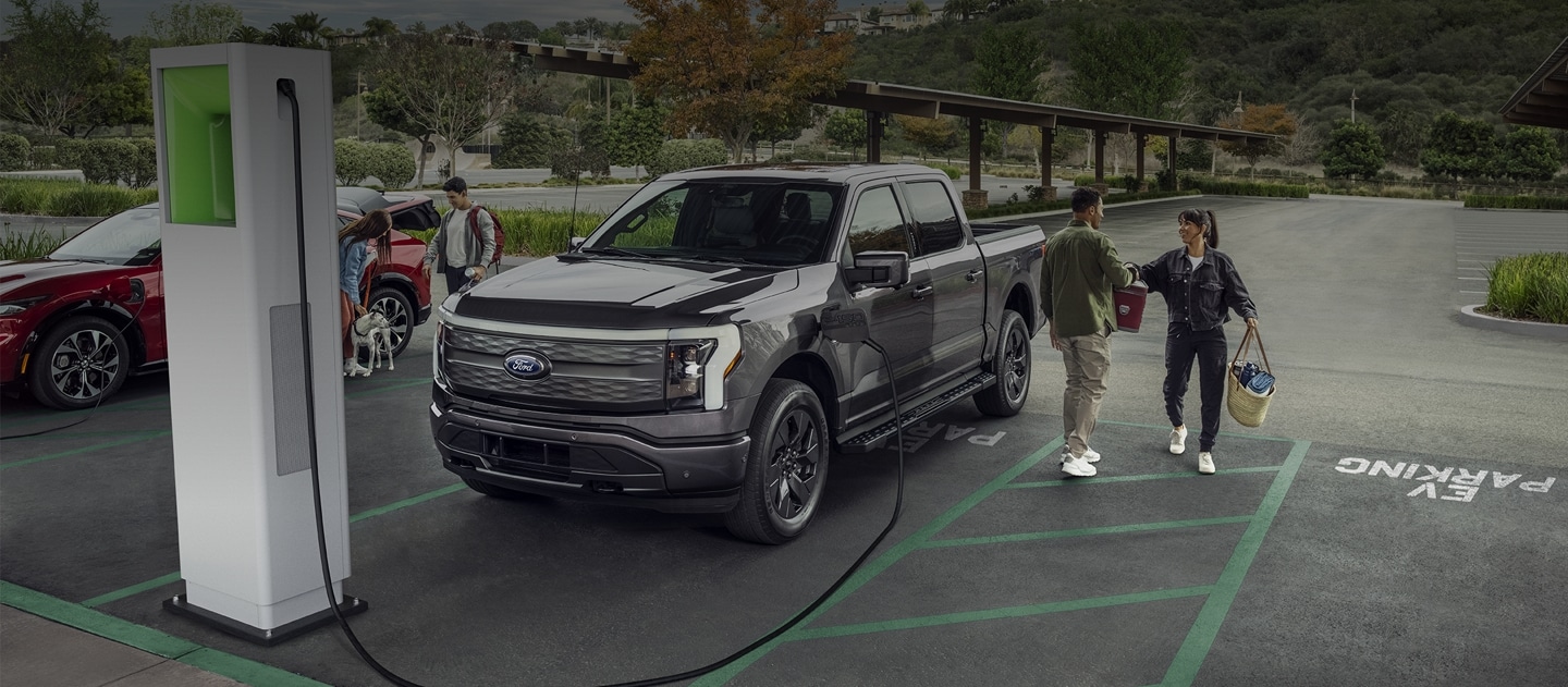 Ford vehicles parked at a public charging station.