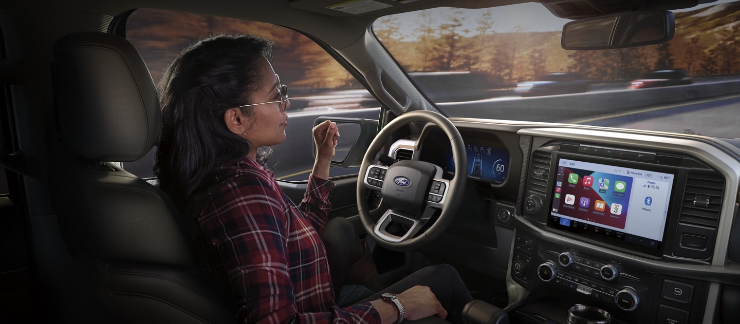 Woman drives a Ford vehicle hands-free.