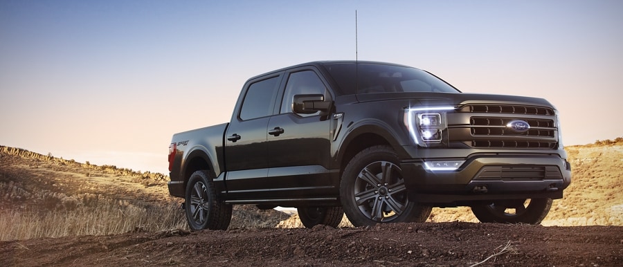 2022 Ford F-150® LARIAT in Agate Black parked on a rocky hill
