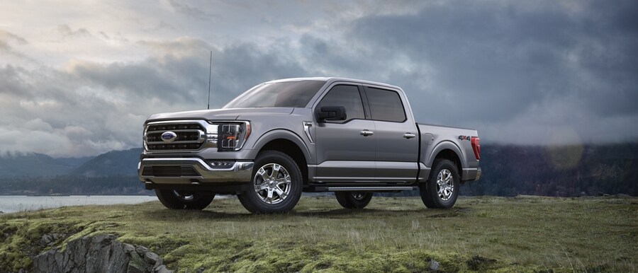 2022 F-150® XLT in Iconic Silver parked on a bluff overlooking a lake